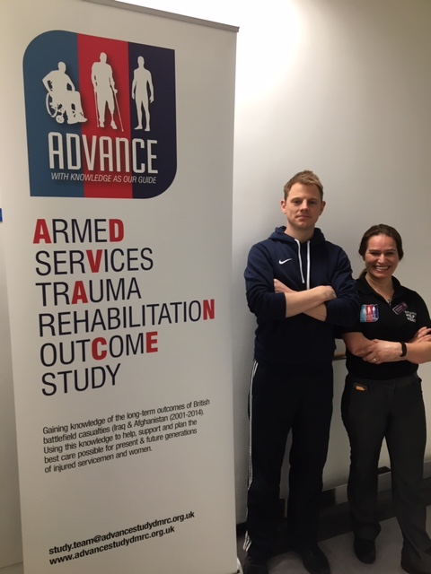 ADVANCE participant Jonathan Grave and staff member Mel Kaya-Barge standing next to an ADVANCE banner